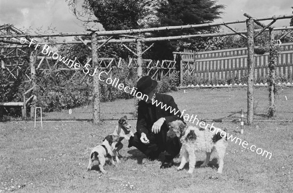 PRIEST AT PAROCHIAL HOUSE WITH DOGS